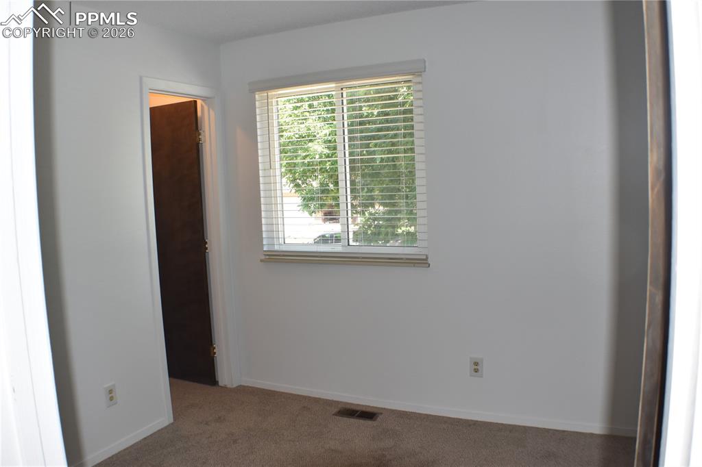 Image 15 of 40: Empty room with carpet floors and baseboards