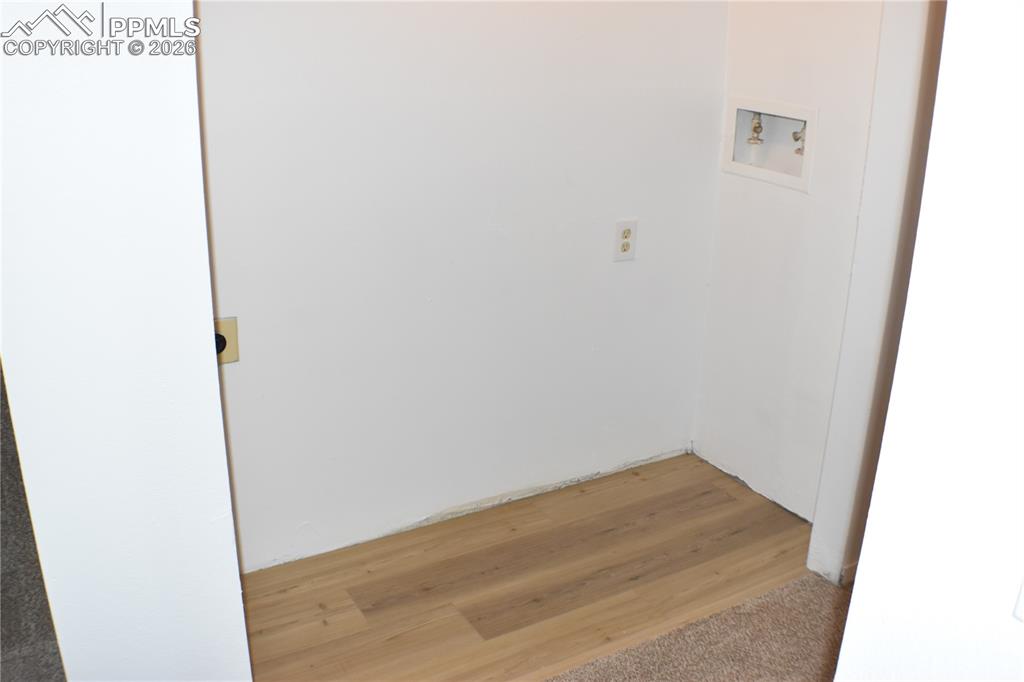 Image 20 of 40: Washroom with washer hookup and light wood finished floors