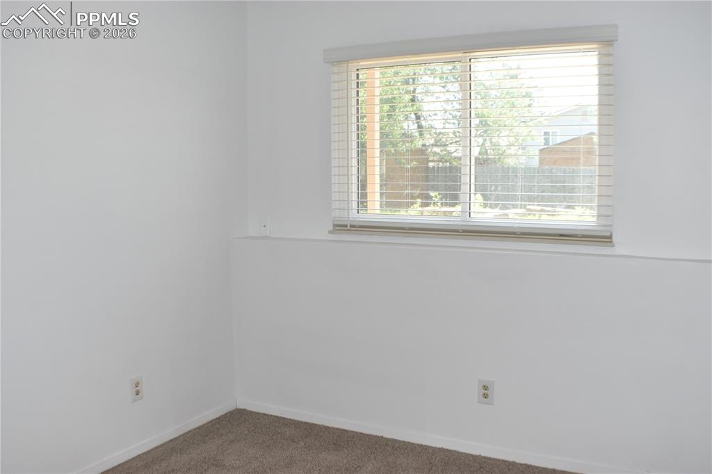 Image 21 of 40: Carpeted spare room featuring baseboards