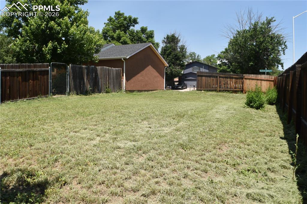 Image 37 of 40: side of additional fenced backyard, could add on to