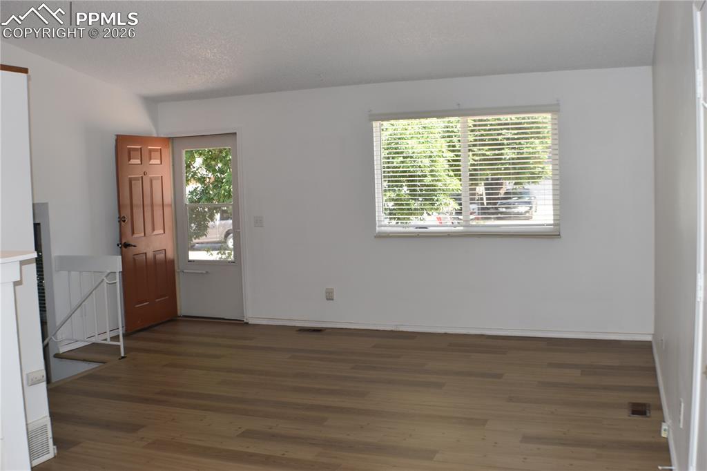 Image 6 of 40: Entrance foyer featuring wood finished floors and baseboards