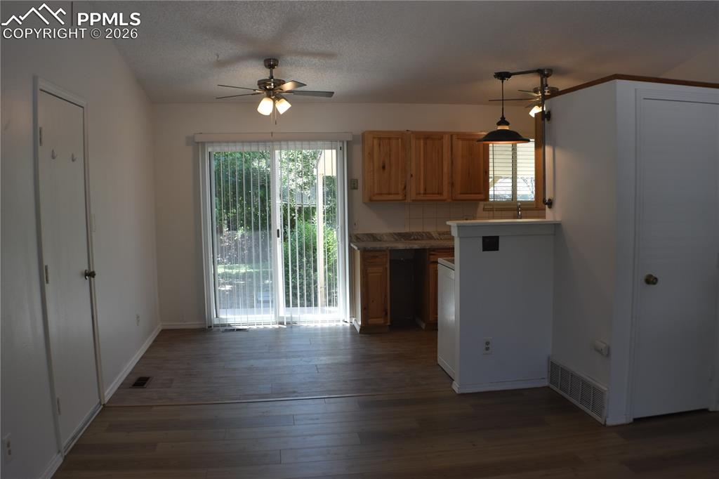Image 9 of 40: Kitchen featuring a ceiling fan, healthy amount of natural light, wood fini
