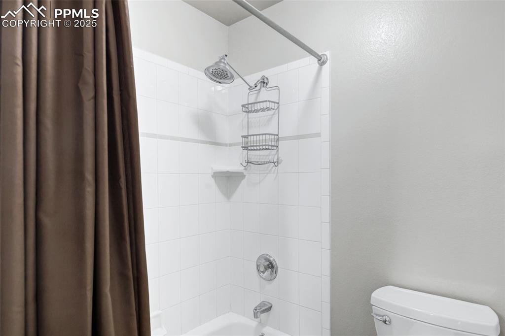 Image 15 of 44: Bathroom with shower / bath combo and toilet