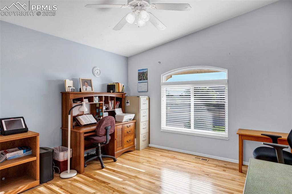 Image 17 of 44: Office featuring wood finished floors, ceiling fan, and vaulted ceiling