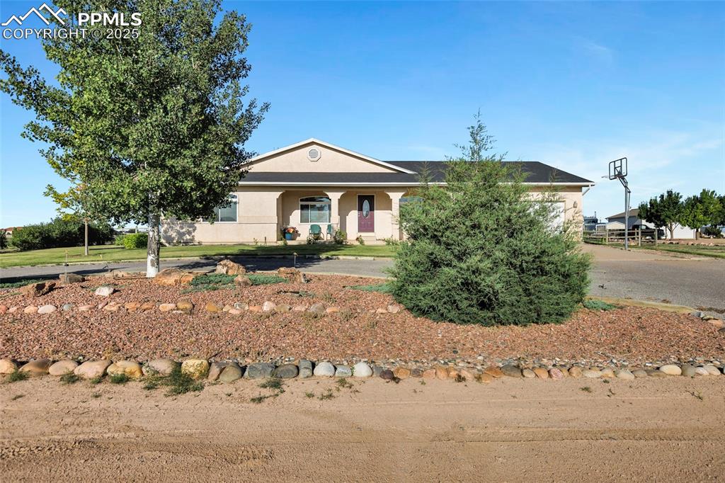 Image 2 of 44: View of front of property with stucco siding and driveway