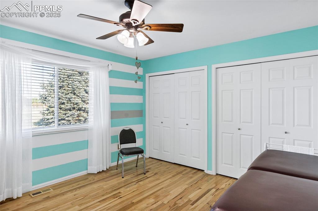 Image 20 of 44: Sitting room with light wood-type flooring and ceiling fan