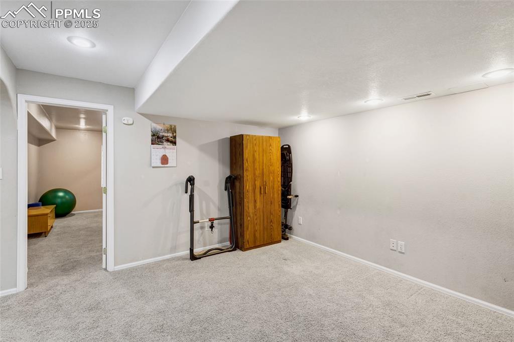 Image 22 of 44: Finished below grade area featuring carpet and baseboards