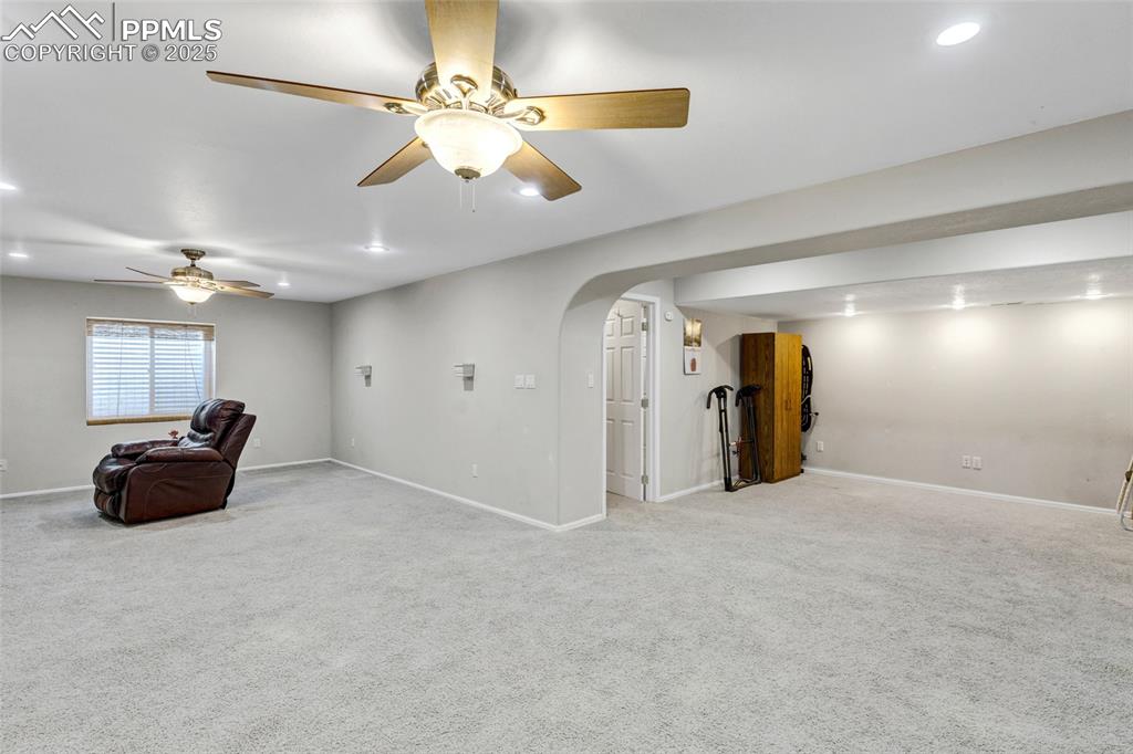 Image 24 of 44: Unfurnished room with arched walkways, light colored carpet, recessed light