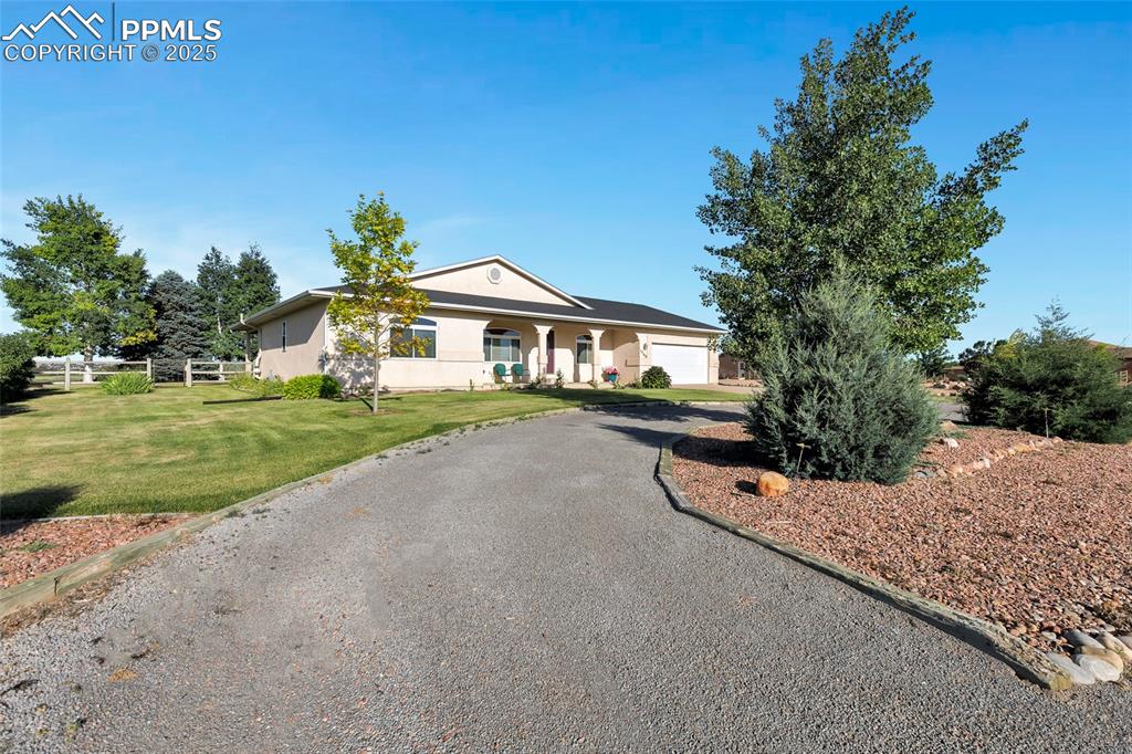 Image 3 of 44: View of front facade featuring stucco siding, driveway, and a garage