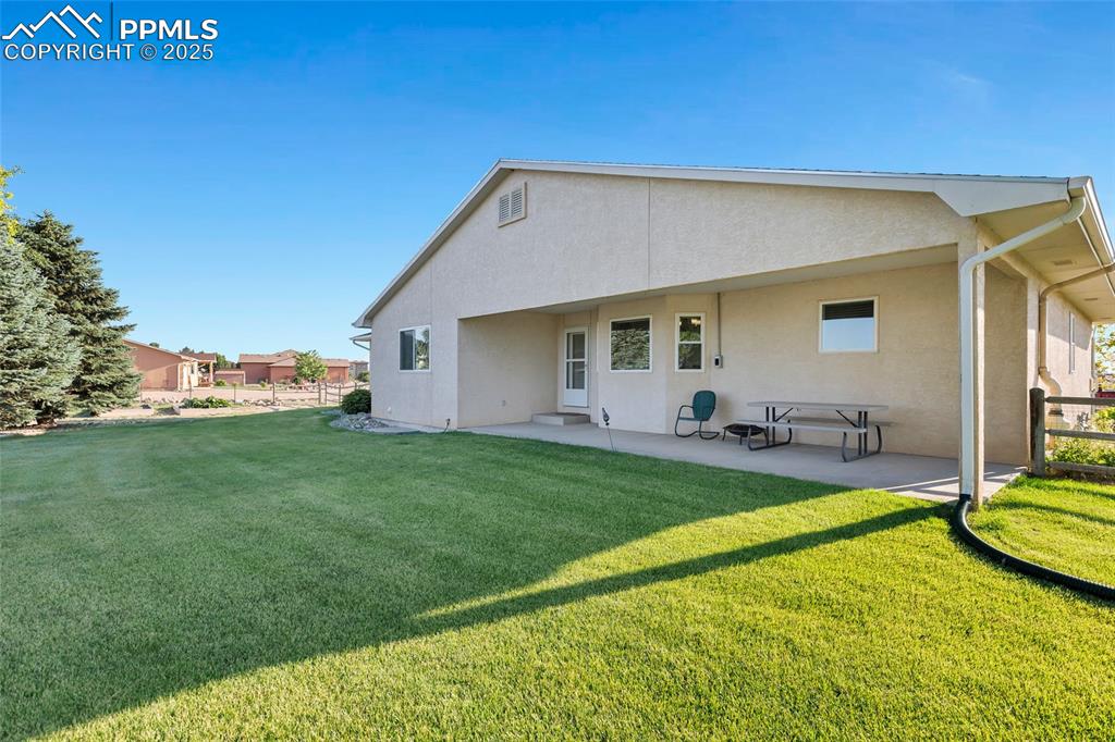Image 31 of 44: Back of house featuring stucco siding and a patio