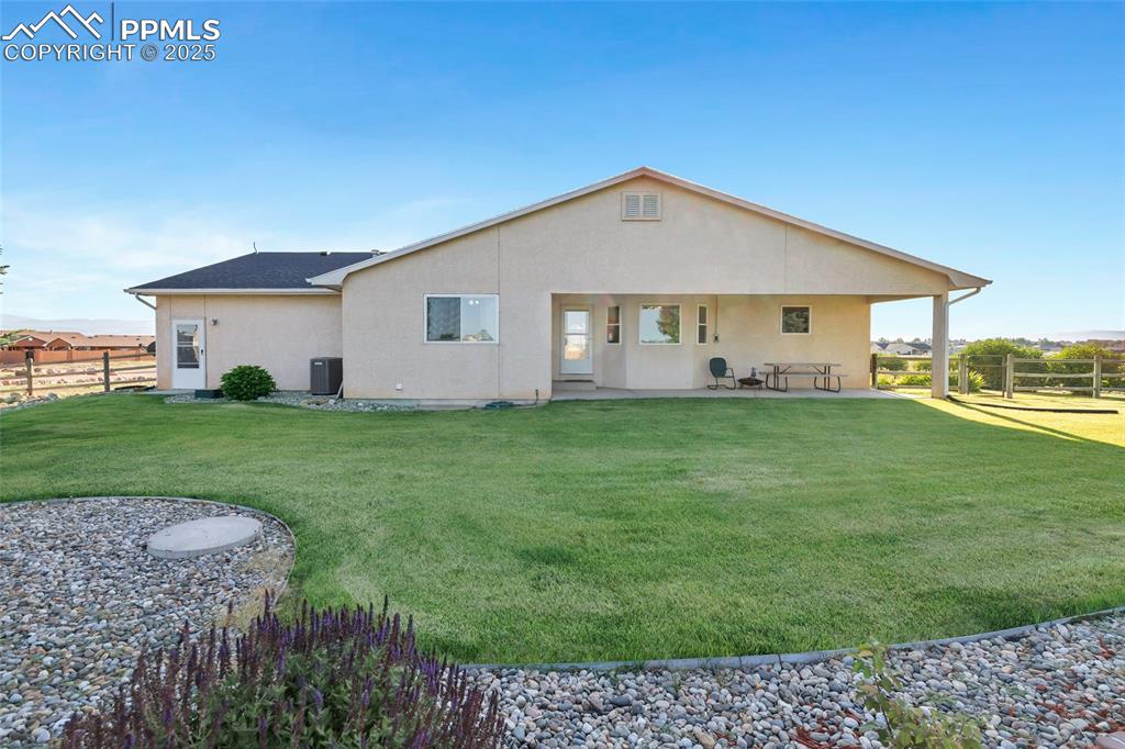 Image 32 of 44: Rear view of property featuring a patio area and stucco siding