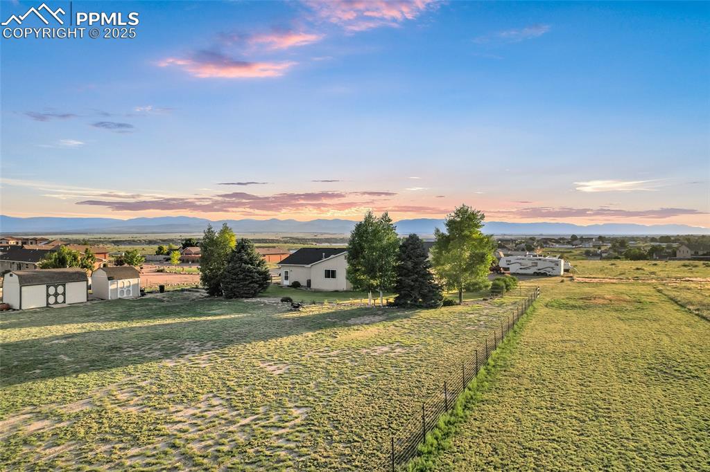 Image 44 of 44: Yard at dusk with a shed and a barn mountain view 