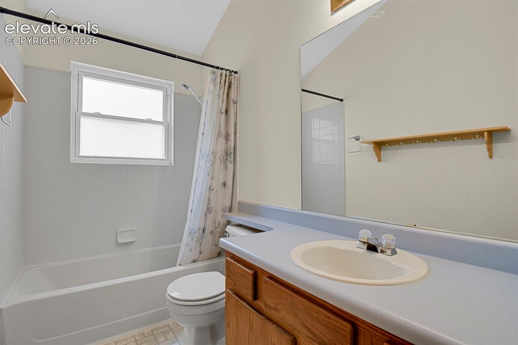 Image 16 of 48: Bathroom featuring a white tub, white tiled shower surround, and a vanity w