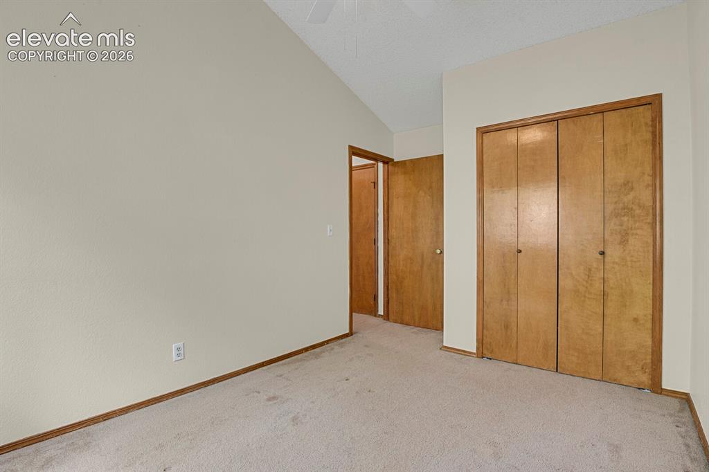 Image 18 of 48: Interior space featuring a vaulted ceiling and light-toned walls