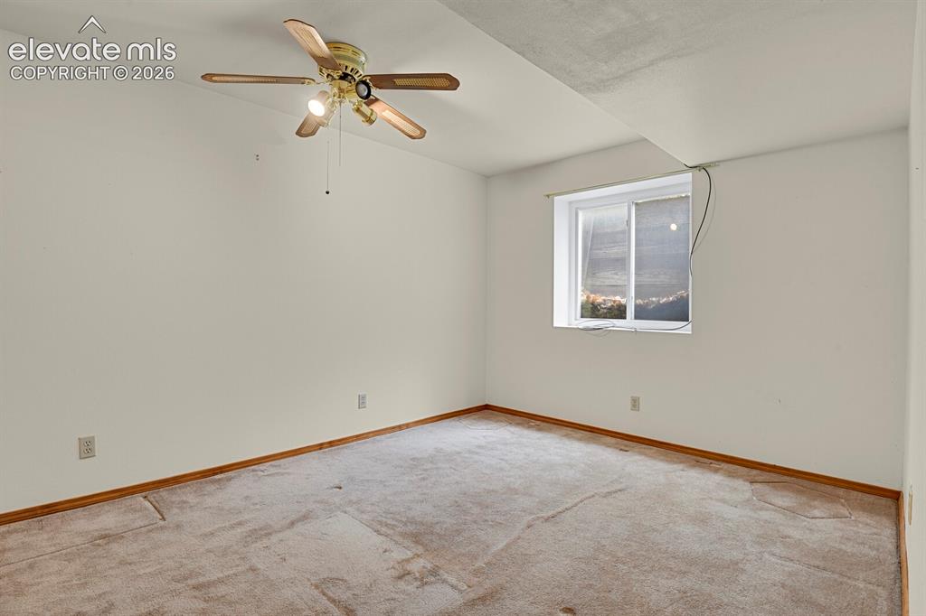 Image 22 of 48: Carpeted room with a ceiling fan, recessed window, and light wood-finish ba