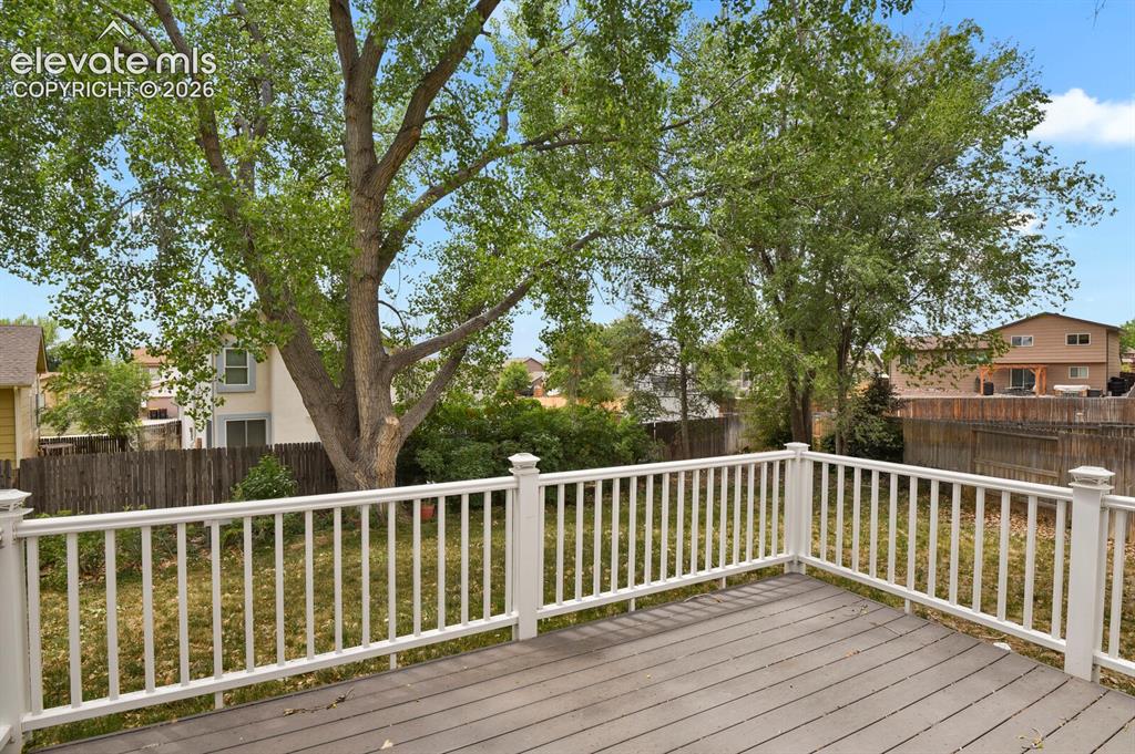 Image 33 of 48: Expansive outdoor deck with gray composite decking and white railings