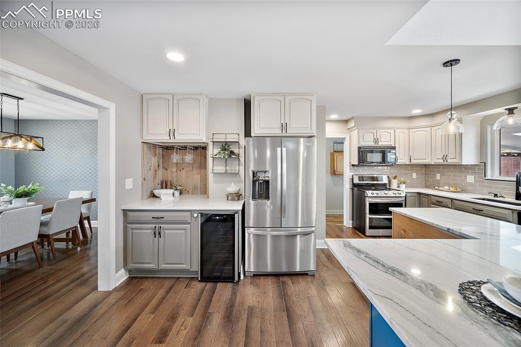 Image 16 of 50: Beverage area with mini refrigerator.