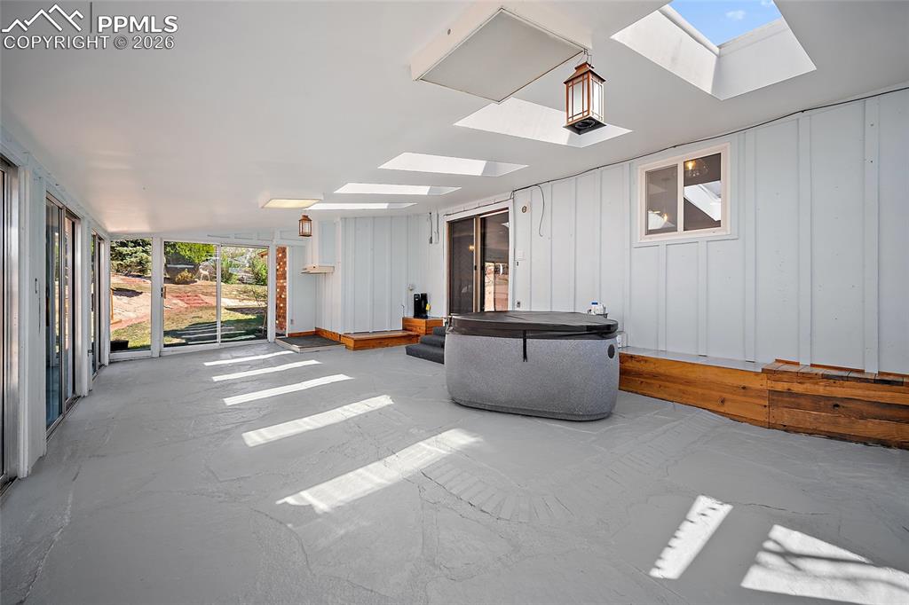 Image 36 of 50: Enclosed sunroom with tons of light.