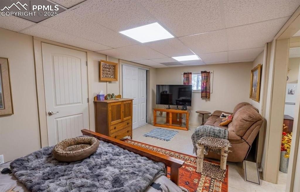 Image 7 of 23: Rear view of property featuring a patio area, driveway, a deck, stairs, and