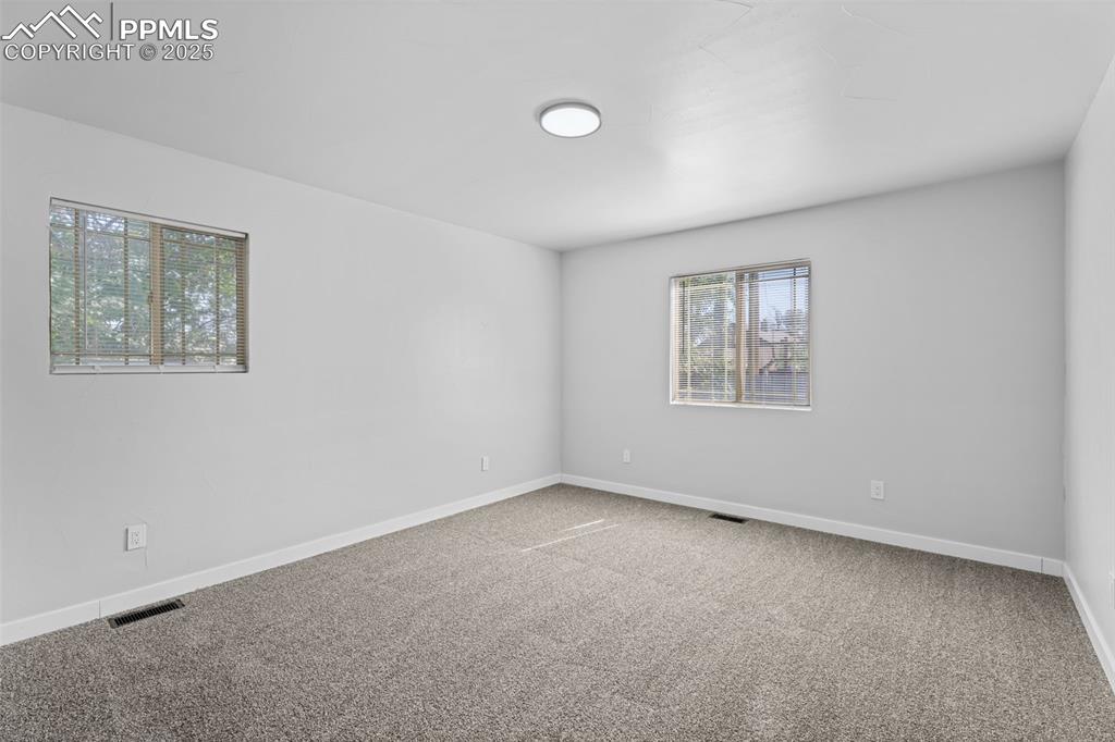 Image 15 of 32: Carpeted empty room featuring baseboards