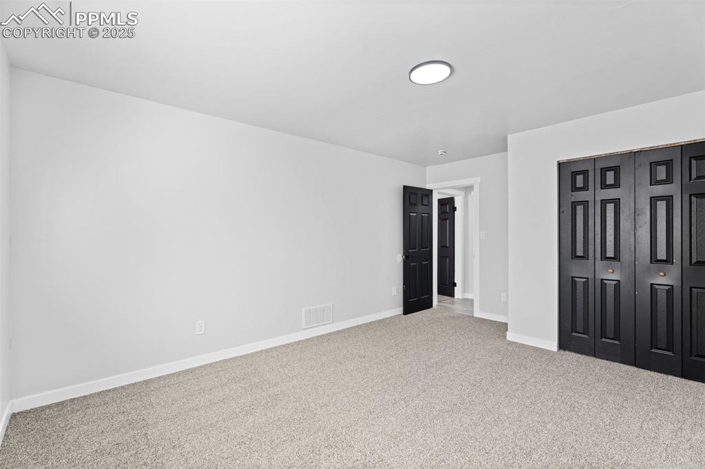 Image 16 of 32: Unfurnished bedroom featuring carpet and a closet
