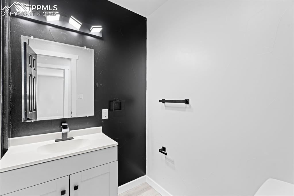 Image 17 of 32: Bathroom featuring vanity and light wood-style flooring