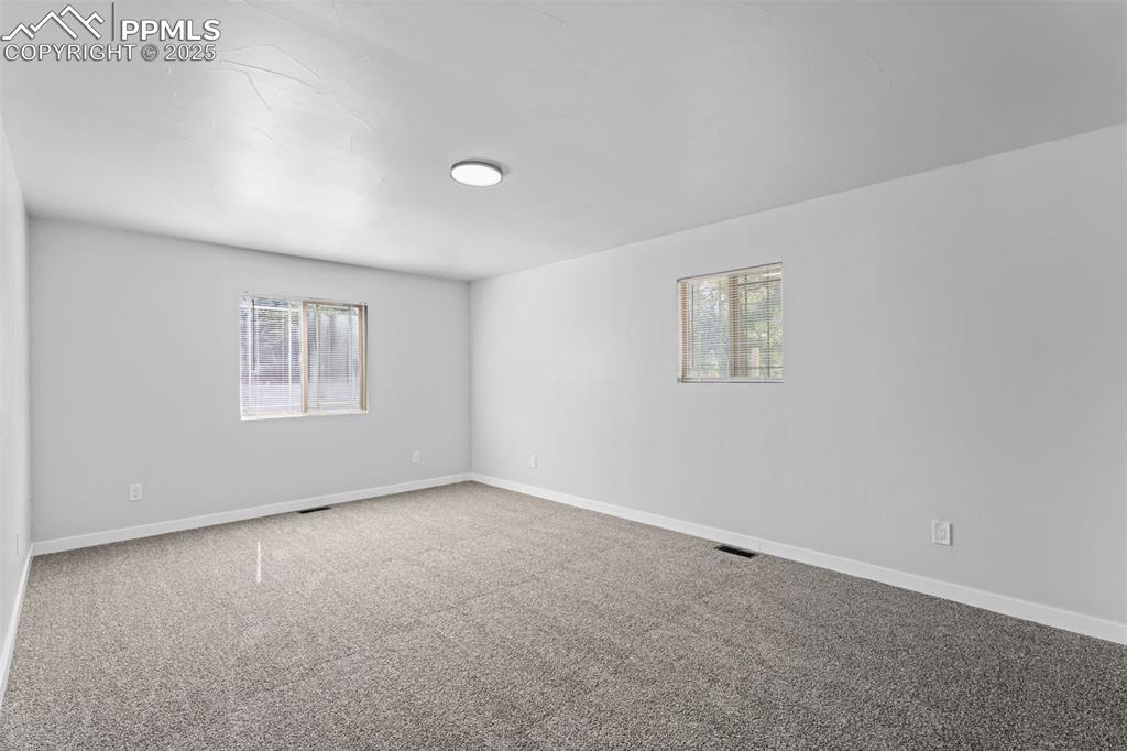 Image 18 of 32: Empty room featuring carpet floors and baseboards