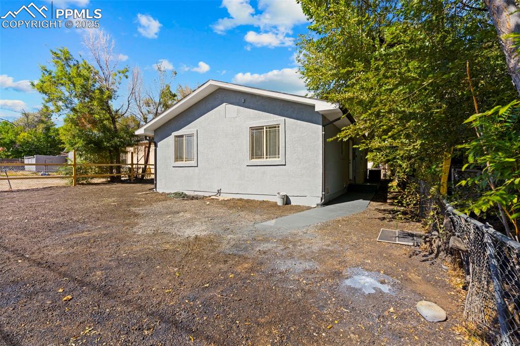 Image 31 of 32: Back of property with stucco siding