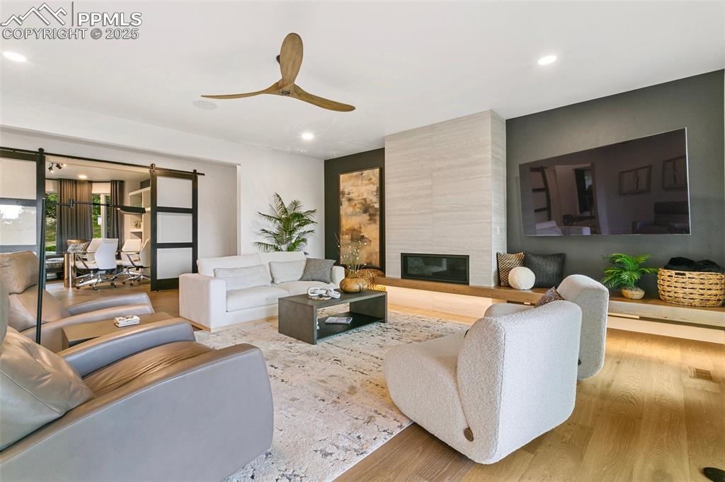 Image 14 of 50: A Floating wood hearth grounds the focal point of the Great Room. Glass bar