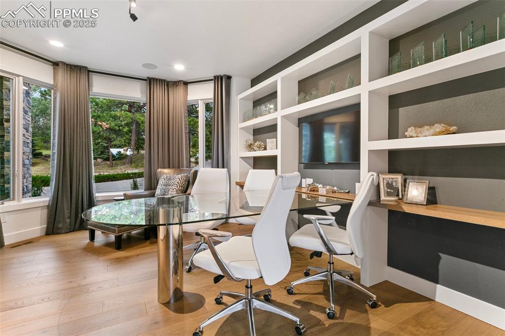 Image 17 of 50: Built-in Display shelves are balanced by a large storage closet (not pictur