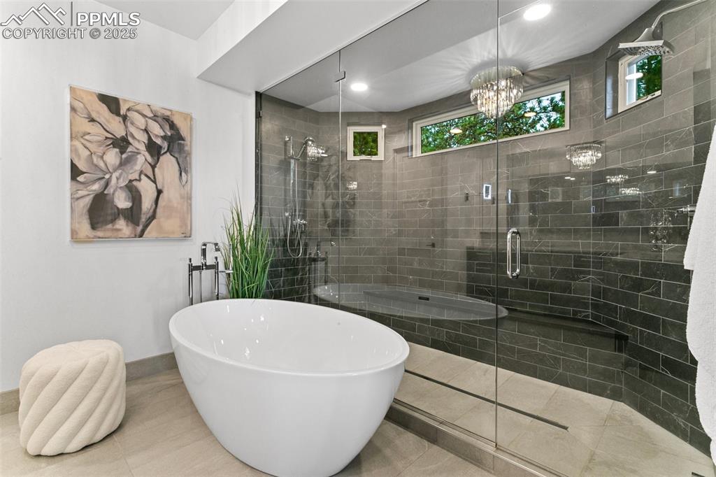 Image 22 of 50: Your own spa at home! Enjoy heated floors and more views from the soaking t