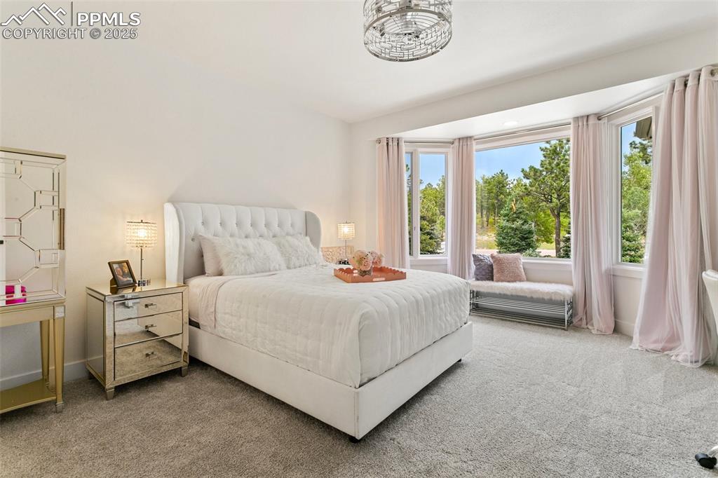 Image 28 of 50: Junior Ensuite Bedroom on the upper level with bay window sitting area.