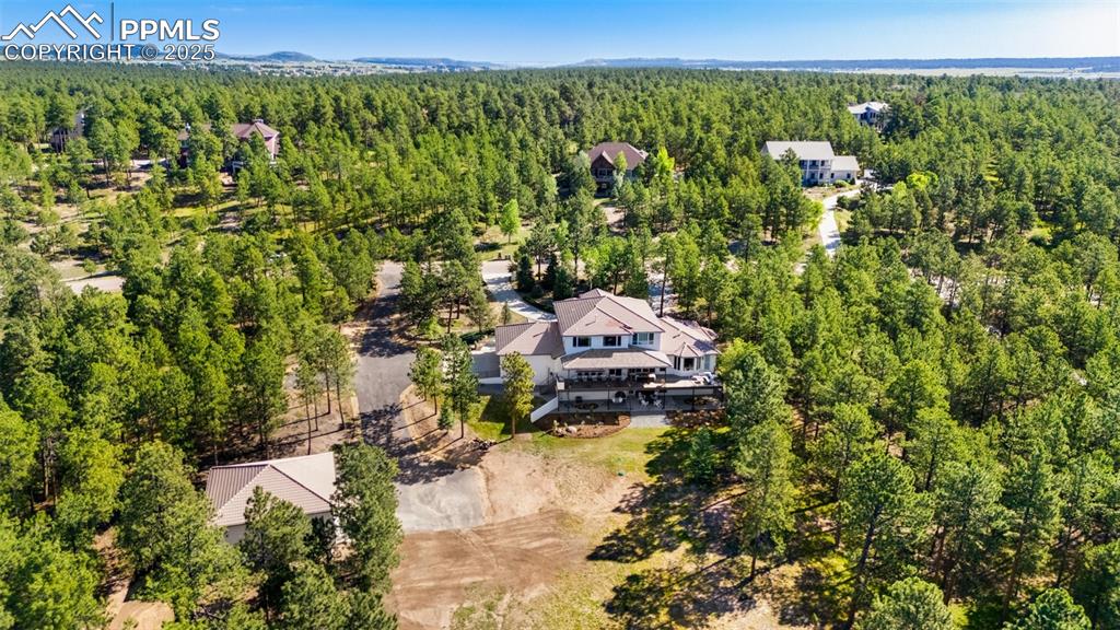 Image 49 of 50: Back side aerial view of the home and RV Garage.