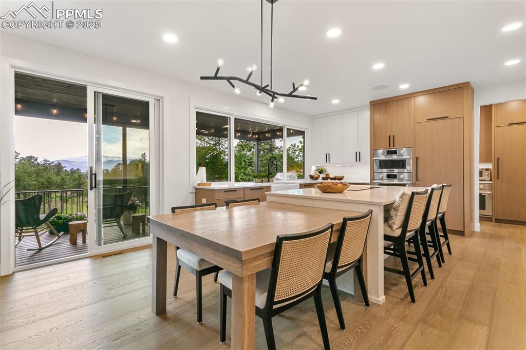 Image 5 of 50: Built-in White Oak Table expands the eat-in kitchen seating