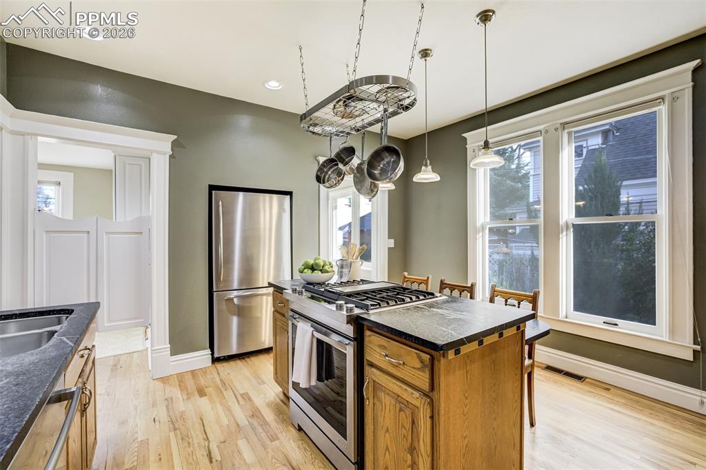 Image 17 of 50: Kitchen offers abundant light and functionality while maintaining historic 