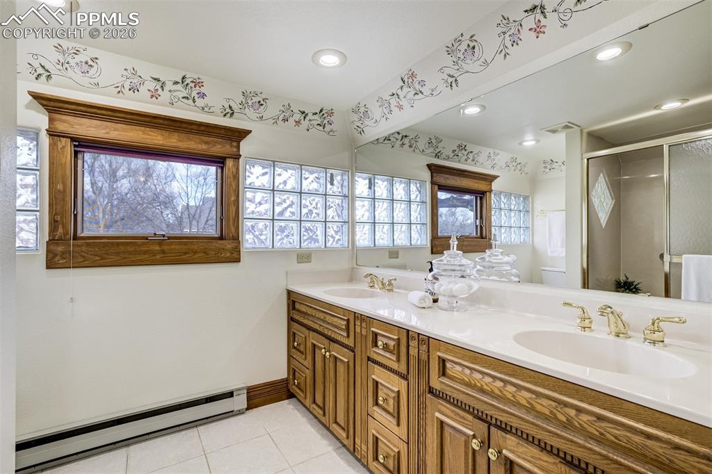 Image 28 of 50: Primary bathroom with double sink and storage!