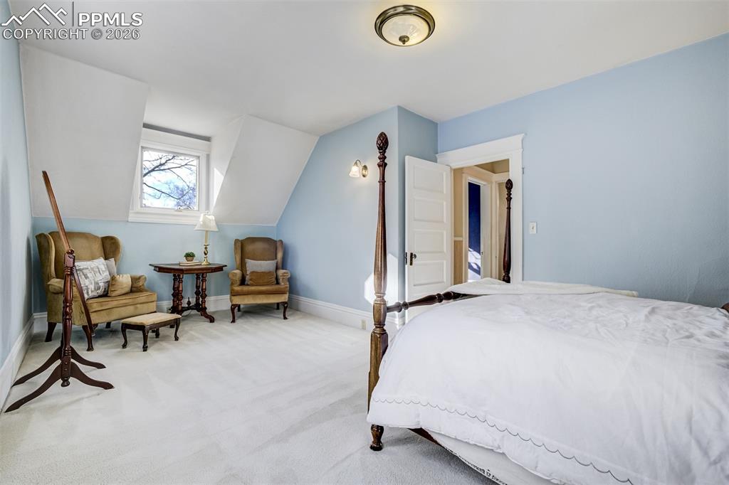 Image 31 of 50: Second bedroom features a sitting area 