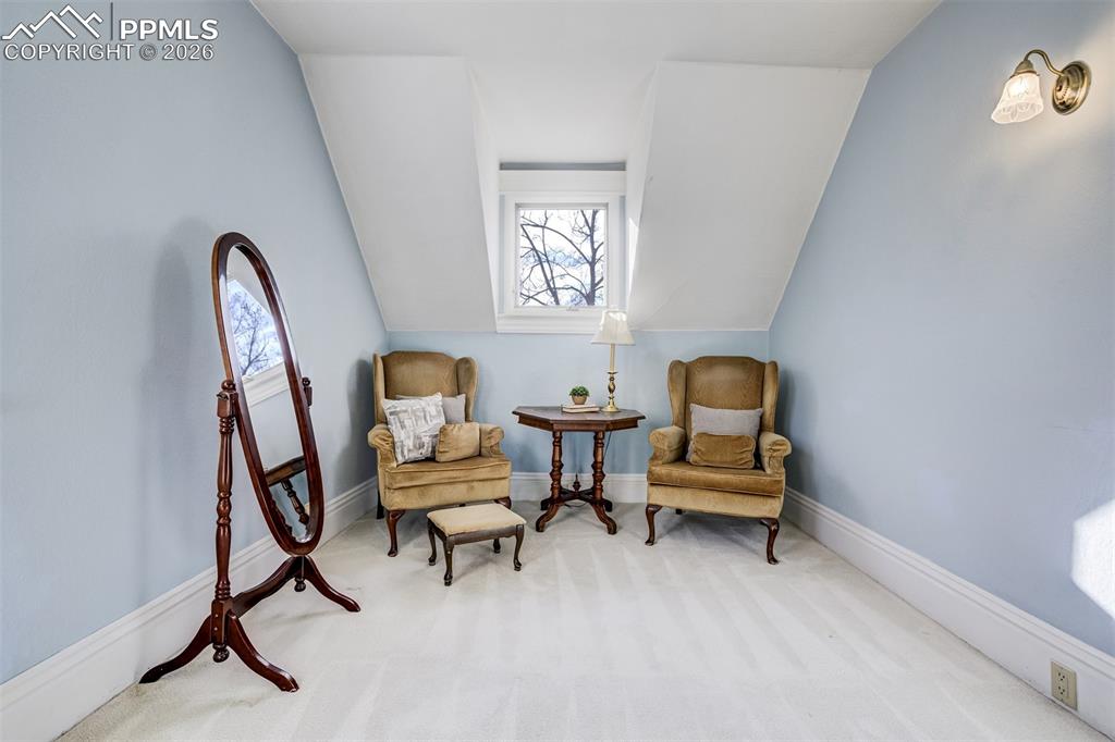 Image 33 of 50: Sitting area in second bedroom is charming