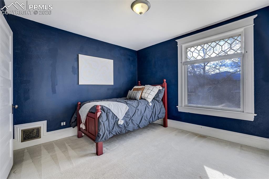 Image 35 of 50: Third bedroom upstairs with window to front of home