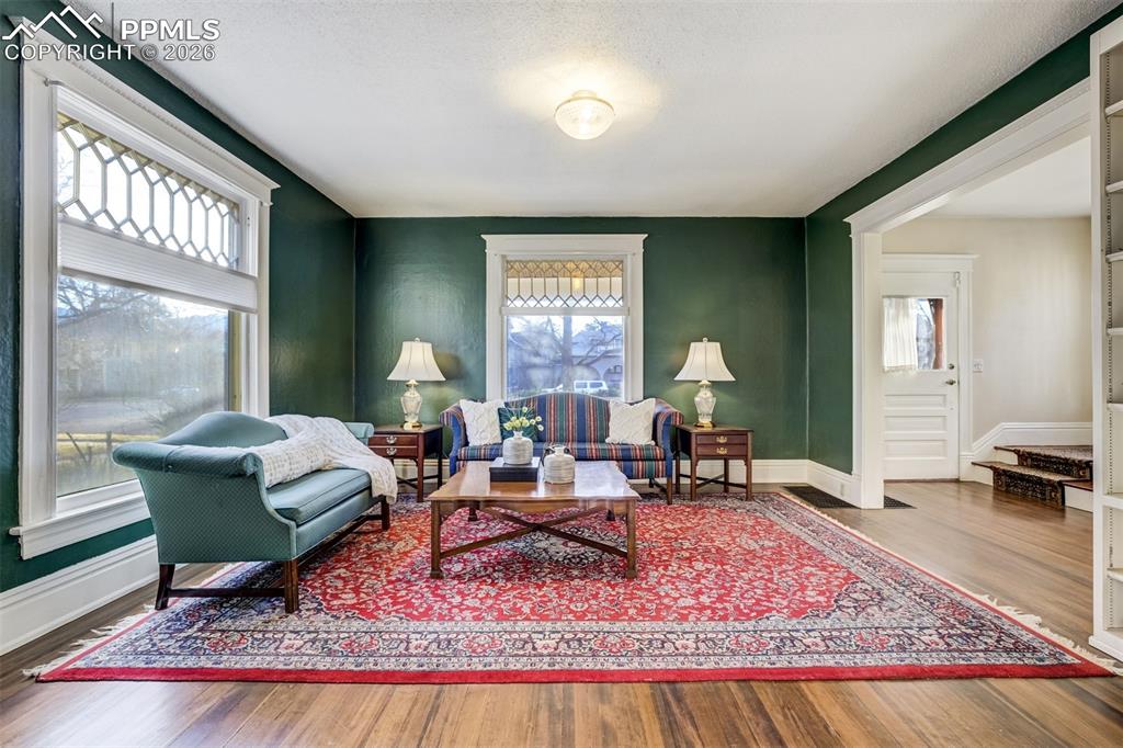 Image 5 of 50: Living Room off main entry way - gorgeous light and original wood floors!