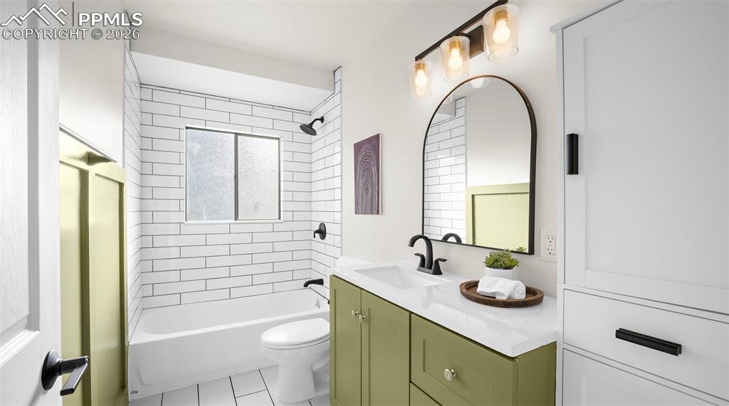 Image 19 of 32: Bathroom featuring vanity, shower combination, and light tile patterned fl