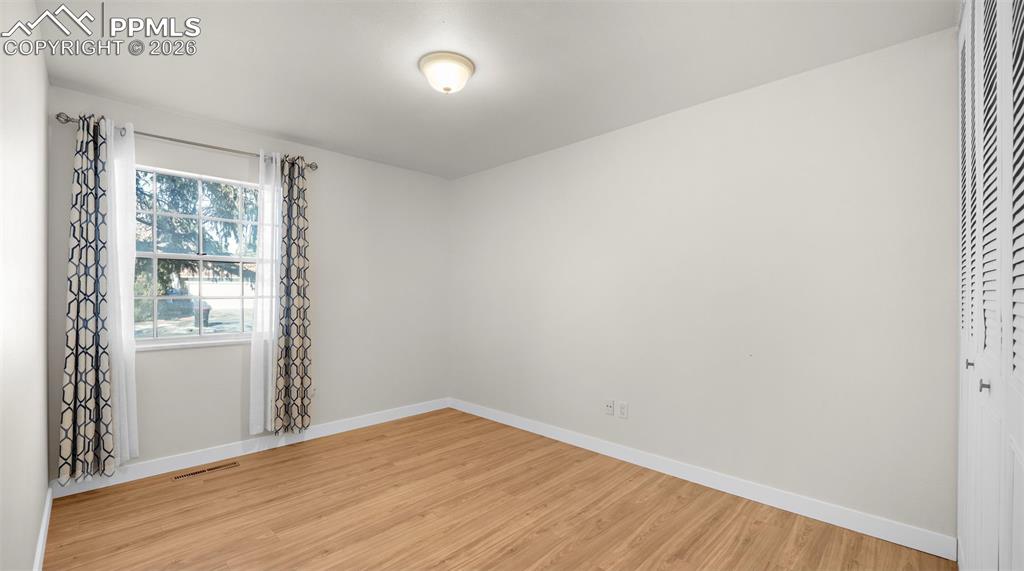Image 20 of 32: Spare room featuring light wood-style floors and baseboards