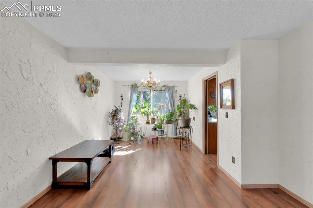 Image 11 of 32: Dining area off living room with doorway to kitchen 