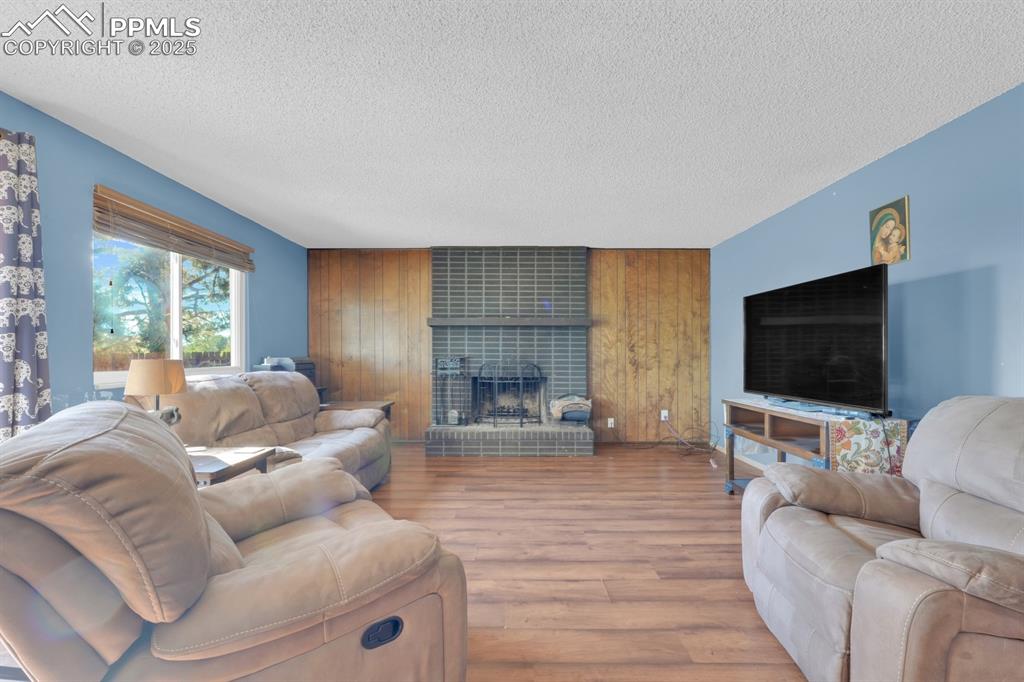 Image 17 of 32: Family room with fireplace and walk out to patio