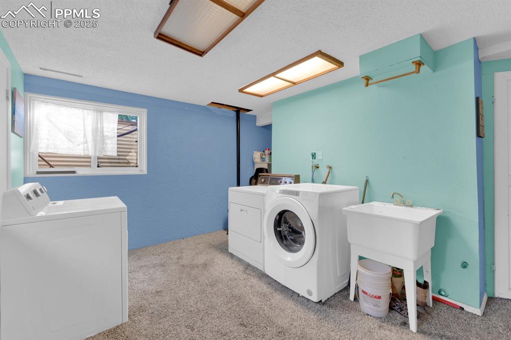 Image 24 of 32: Large laundry room featuring utility sink