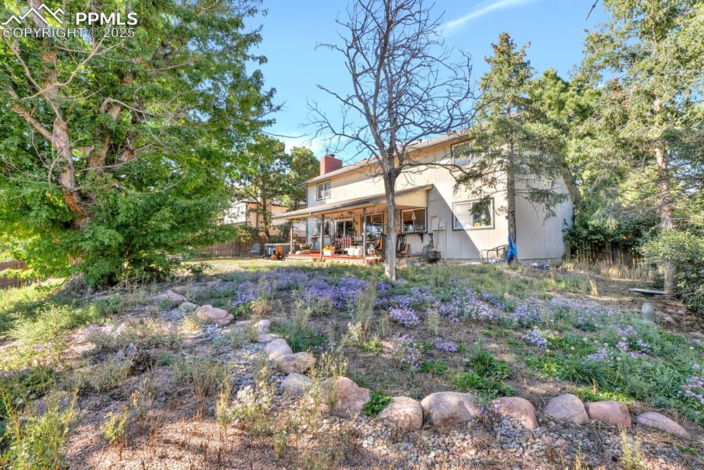 Image 5 of 32: Back of property with covered patio