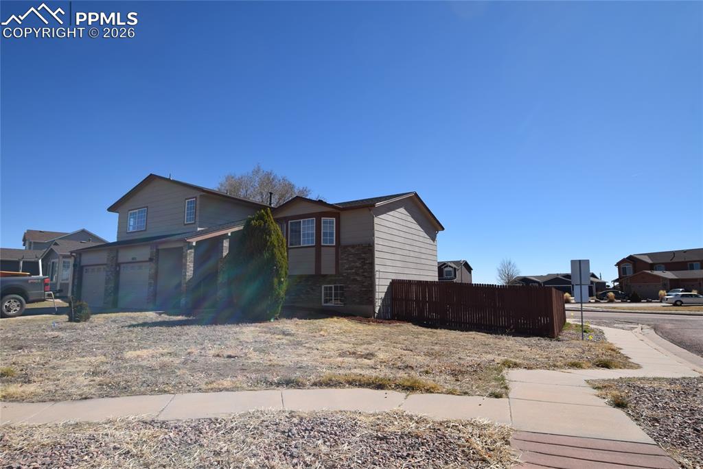 Image 2 of 42: The property features a two-story exterior with light-colored siding and st
