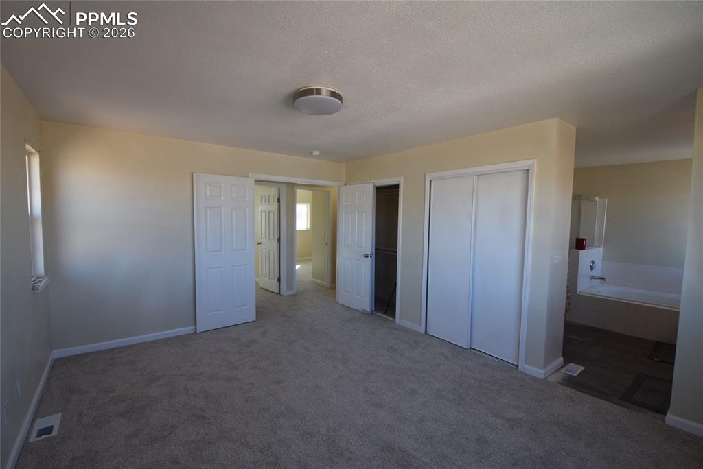 Image 20 of 42: Bright and inviting room featuring light-colored walls and plush carpeting