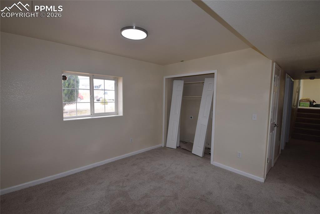 Image 25 of 42: This room features a window providing natural light, a ceiling-mounted ligh