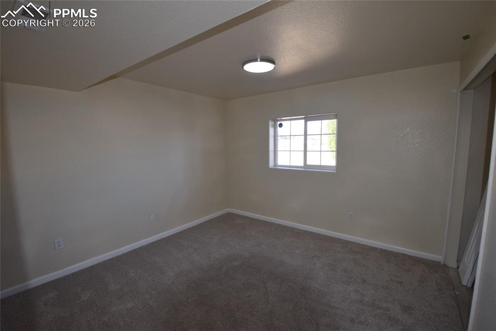 Image 30 of 42: The room features neutral-toned walls, a window providing natural light, an